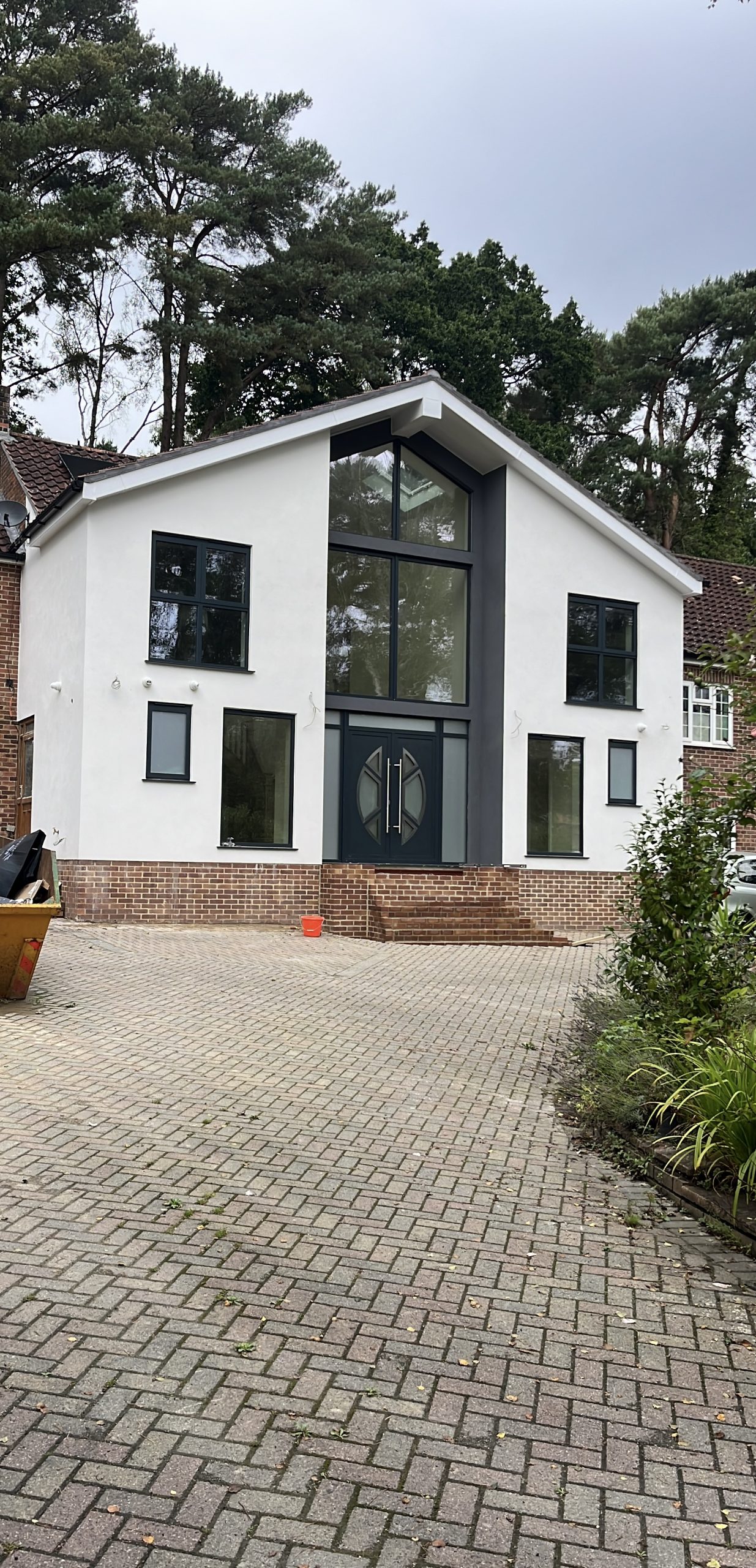 Modern circular-handle aluminium front door, architect-style house