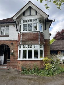 White Georgian-bar bay window under tile-hung gable