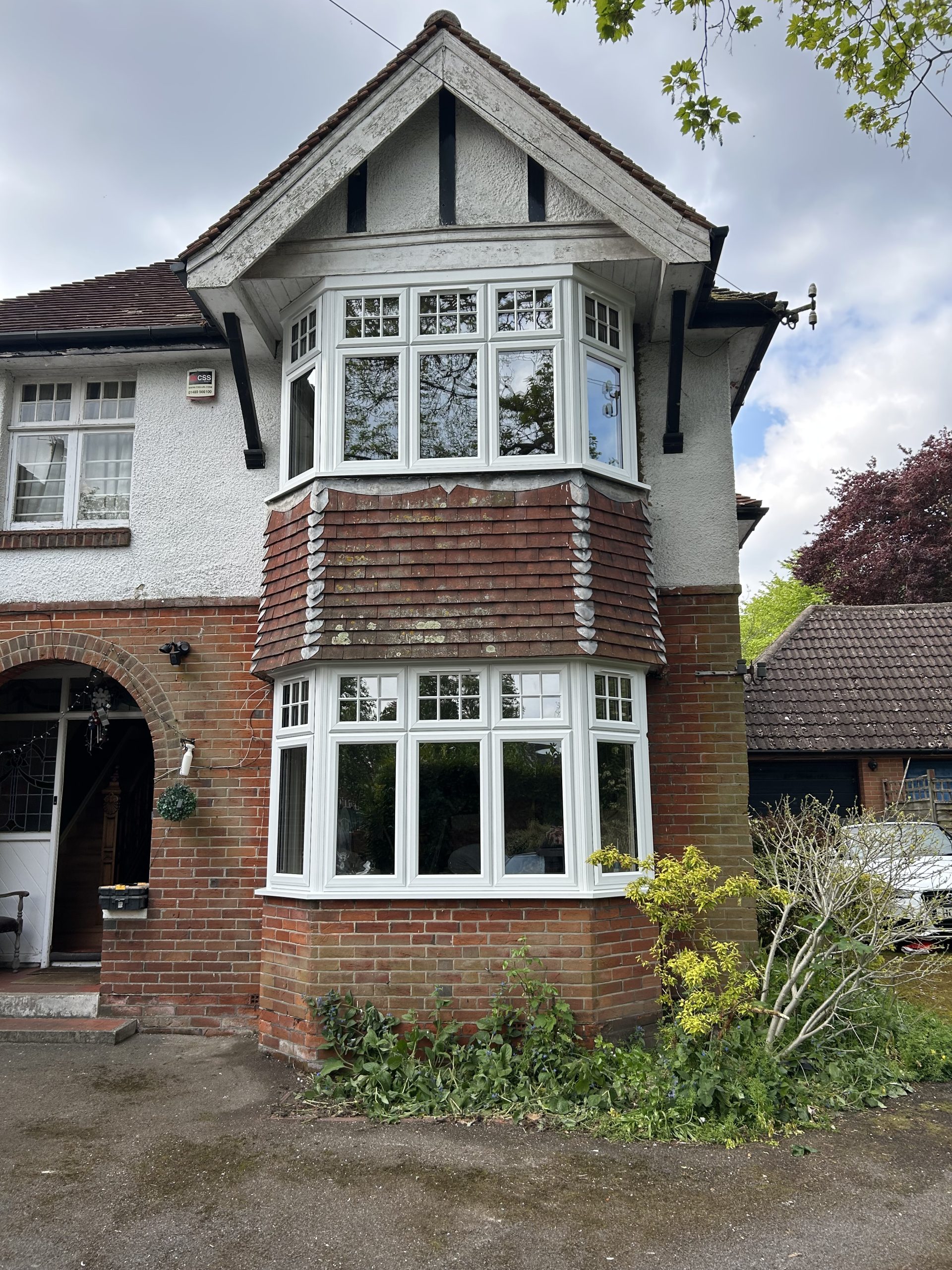 White Georgian-bar bay window under tile-hung gable