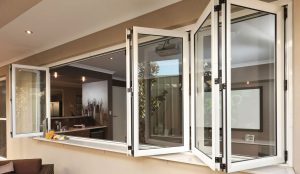 Counter-height bi-fold window serving as a kitchen pass-through