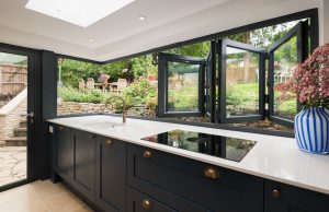 Bi-fold window open over sink looking to garden