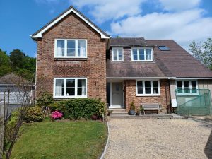 Full house view with new white casement windows