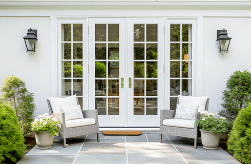 White uPVC French doors opening onto a garden patio