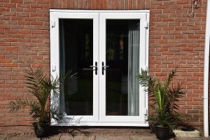 White uPVC French doors, brick house