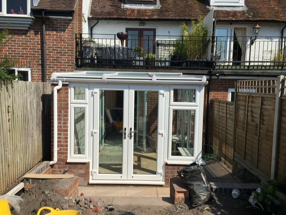 White conservatory addition with French doors and windows
