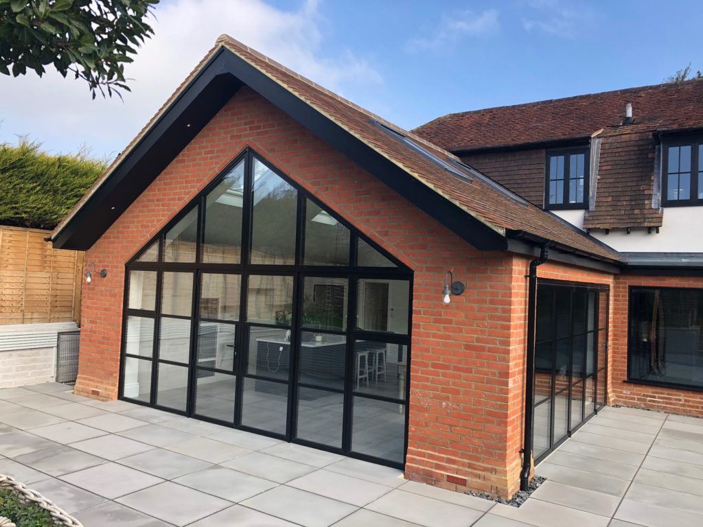Black aluminium glazed gable-end conservatory, red brick