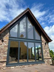 Stone barn conversion with gable-end glazing