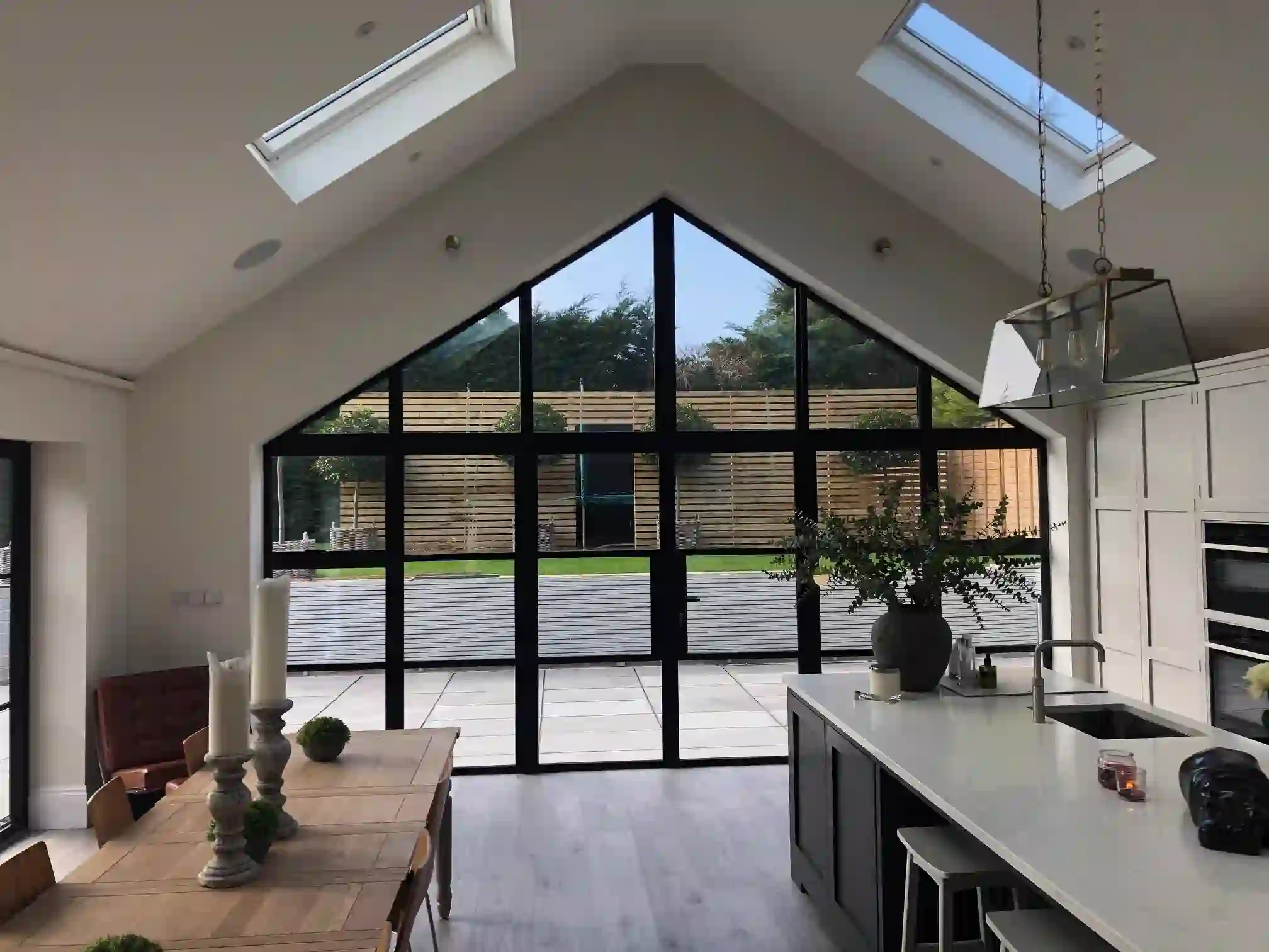 Gable-end glazed extension interior, dark aluminium frame