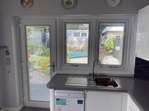 Kitchen door and windows with integral blinds, garden view