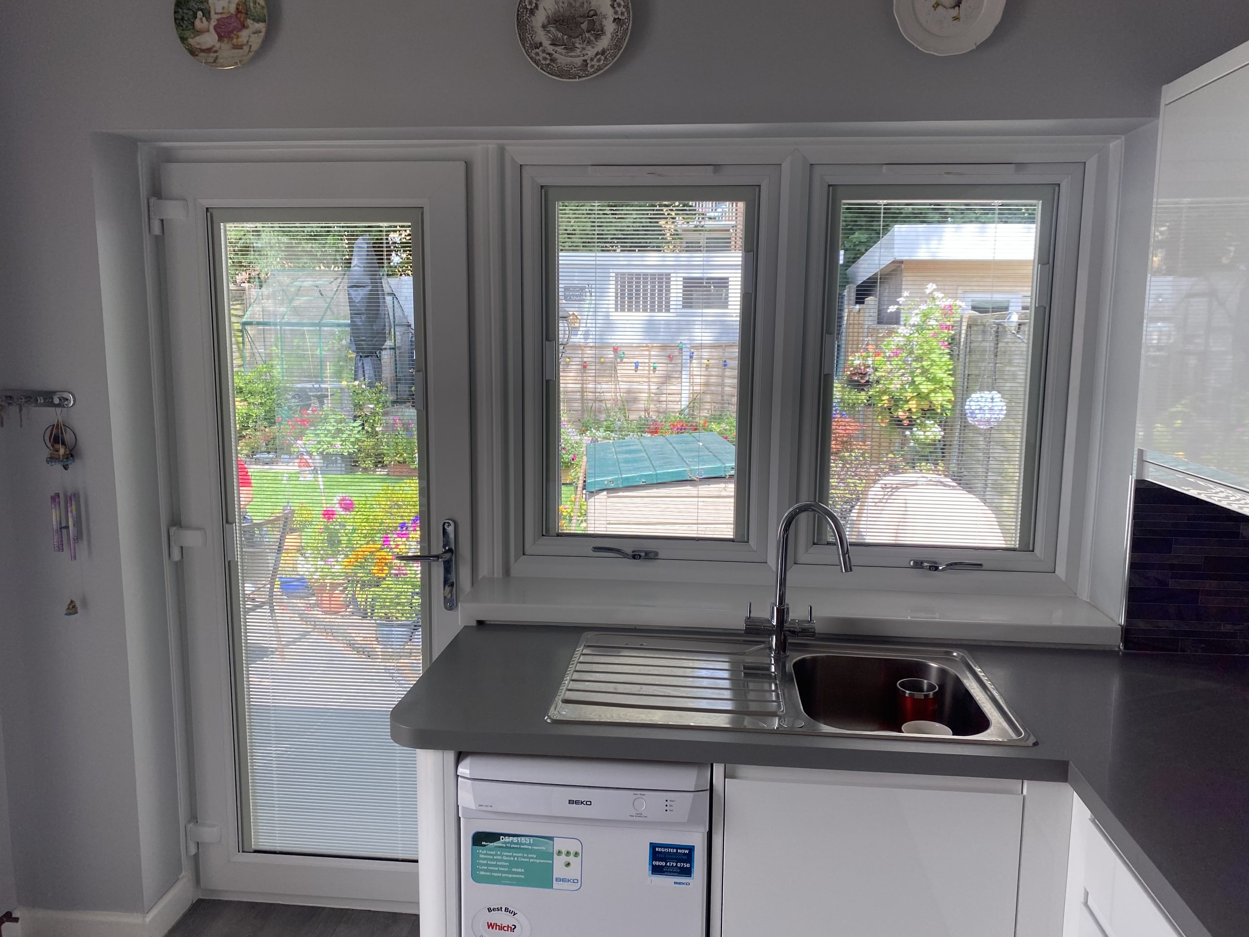 Kitchen door and windows with integral blinds, garden view