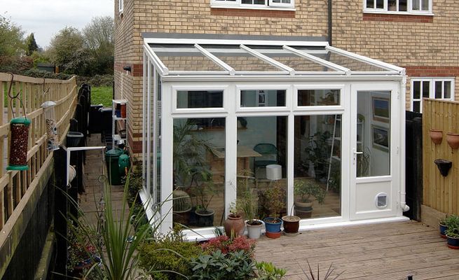 White lean-to conservatory on brick terrace house
