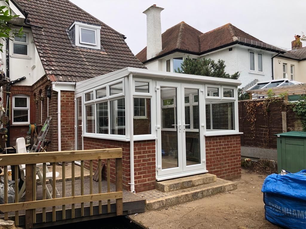 White lean-to conservatory, gable house
