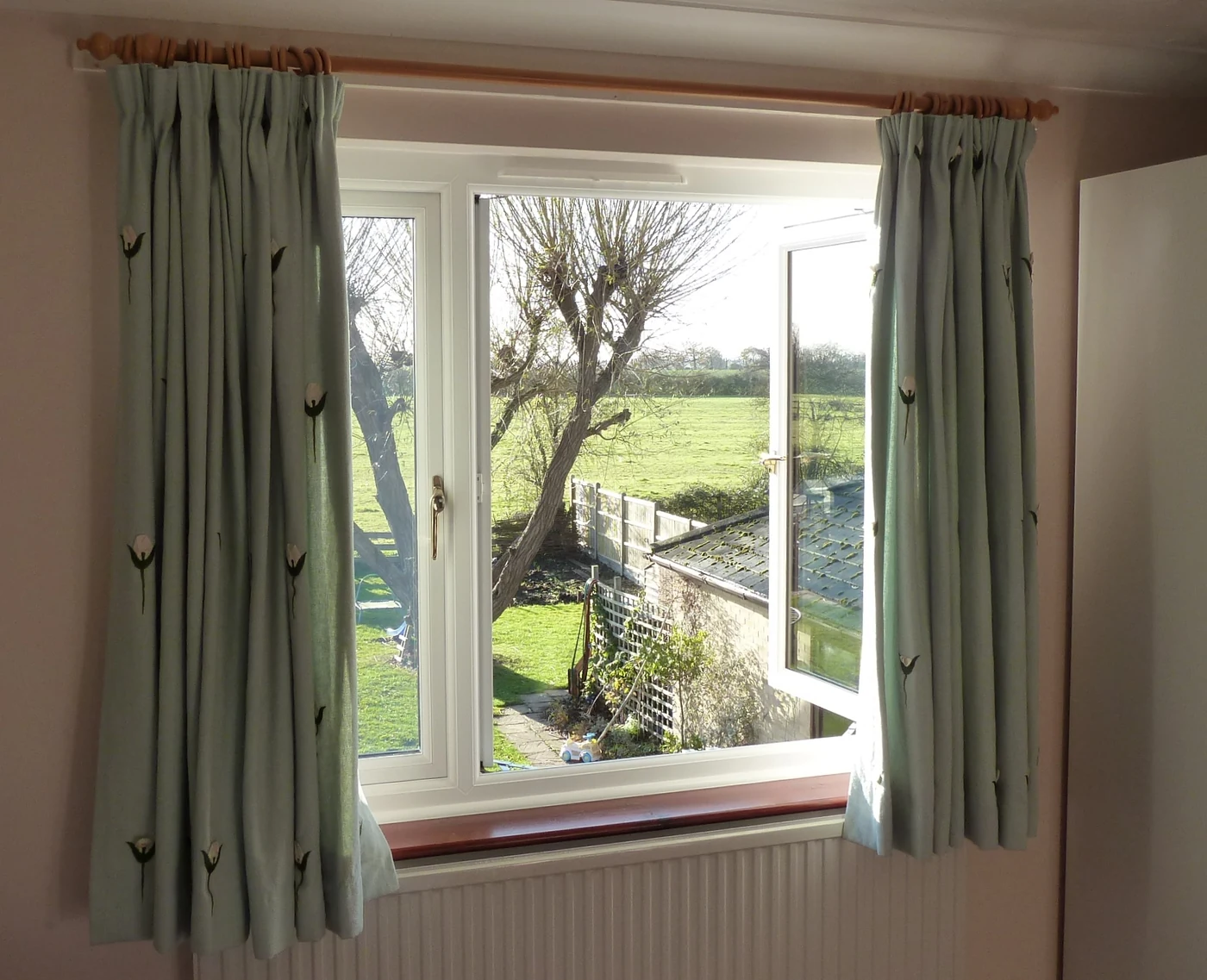 White uPVC French window open onto a garden, Liniar